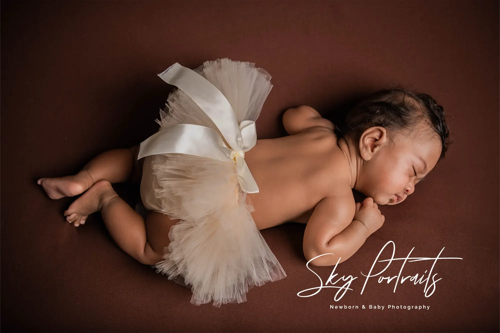 Serene newborn wrapped in natural tones at Sky Portraits, Sydney - newborn photography session